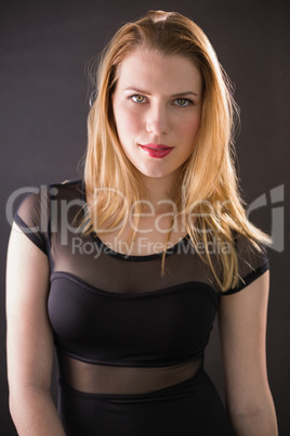 Cheerful gorgeous model wearing elegant dress posing