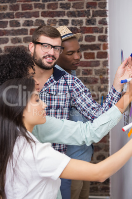 Team looking at sticky notes on wall