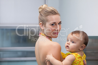 Pretty mother and baby at the swimming pool