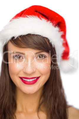 Close up portrait of pretty woman in santa hat smiling