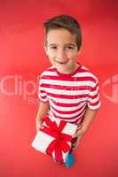 Festive little boy holding a gift