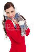 Pretty brunette in winter wear smiling at camera