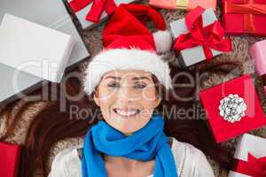 Festive redhead smiling at camera with gifts