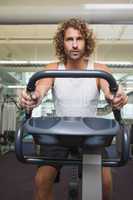 Man working out on exercise bike at gym