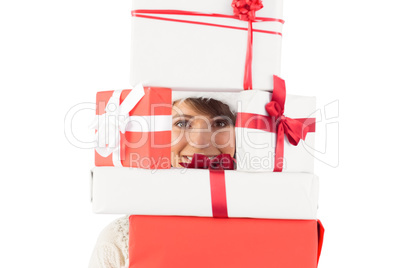 Cute brunette holding pile of gifts