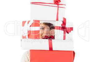 Cute brunette holding pile of gifts