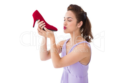 Elegant brunette kissing a shoe
