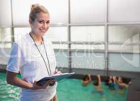 Pretty swimming coach smiling at camera