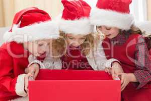 Festive little siblings looking at gift