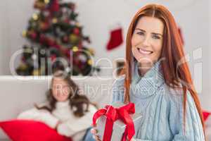 Festive mother holding a gift