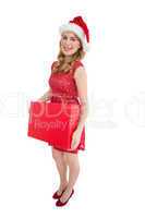 Smiling woman in santa hat holding box