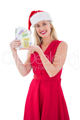 Festive blonde in red dress showing her cash