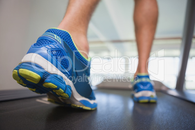 Low section of a man running on treadmill