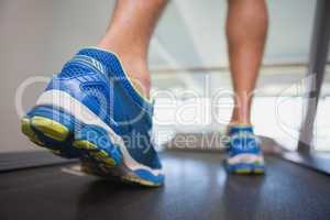 Low section of a man running on treadmill