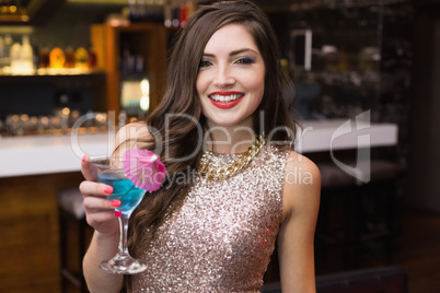 Pretty brunette holding a cocktail