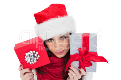 Cheerful brunette holding christmas gifts