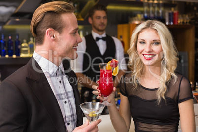 Attractive friends drinking cocktails together