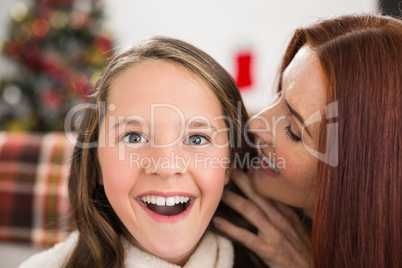 Mother telling her daughter a christmas secret