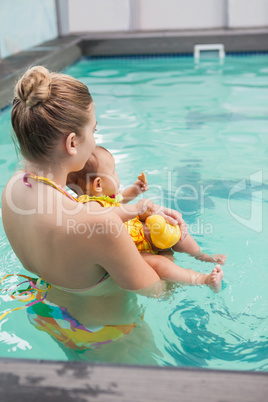 Pretty mother and baby at the swimming pool