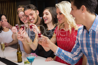 Happy friends having a drink together