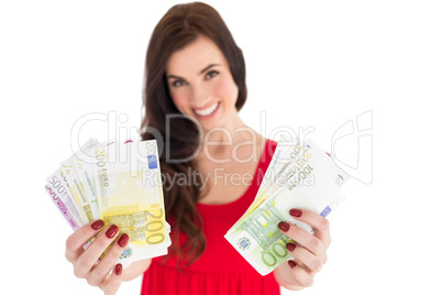 Cheerful brunette showing her cash money