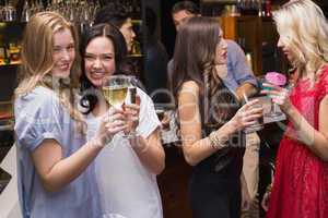 Happy friends having a drink together