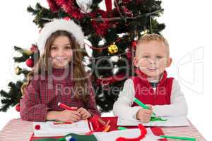Festive little siblings drawing pictures