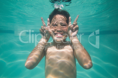 Cute kid posing underwater in pool