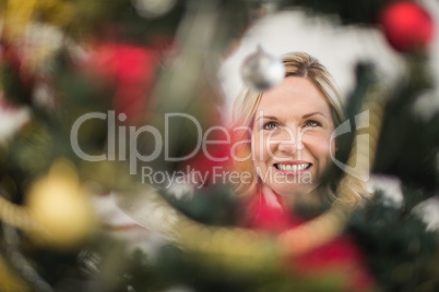 Festive blonde hanging bauble on christmas tree