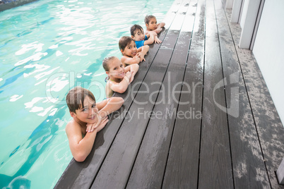 Cute swimming class in the pool