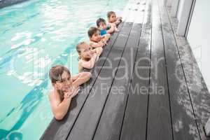 Cute swimming class in the pool