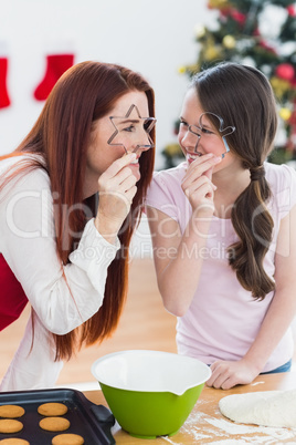 Festive mother and daughter baking together