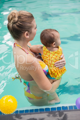 Pretty mother and baby at the swimming pool