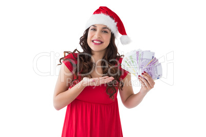 Festive brunette presenting her cash