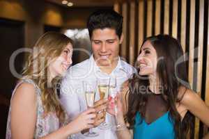 Attractive friends toasting with champagne