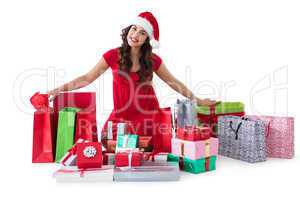 Festive brunette sitting with many shopping bags and gifts