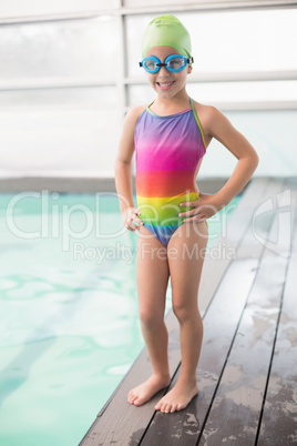 Cute little girl standing poolside