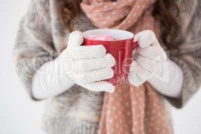 Woman in winter clothes holding a mug Woman in winter clothes holding a mug