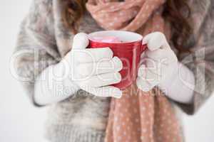 Woman in winter clothes holding a mug