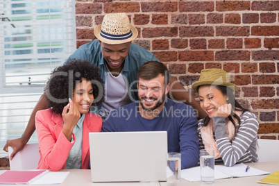 Creative team using laptop in meeting Creative team using laptop in meeting