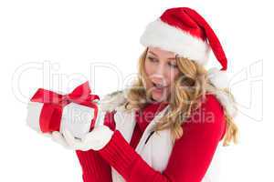 Surprised blonde in santa hat holding gift