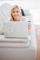 Pretty blonde shopping online with laptop