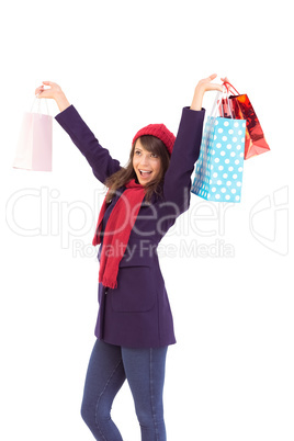 Brunette in winter clothes holding shopping bags