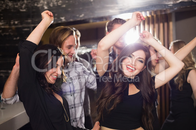 Stylish friends dancing and smiling