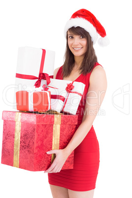 Festive brunette holding pile of gifts