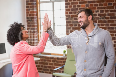 Business people high fiving at office