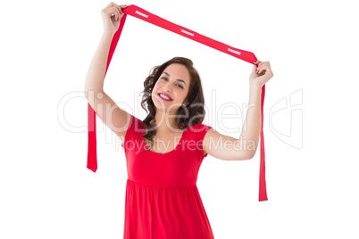 Stylish brunette in red dress holding scarf