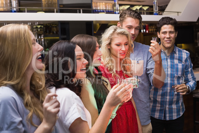 Happy friends having a drink together