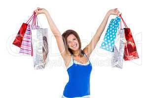 Brunette woman raising shopping bags