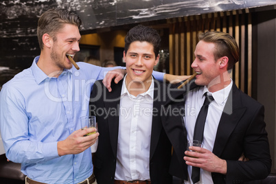 Handsome friends having a drink together